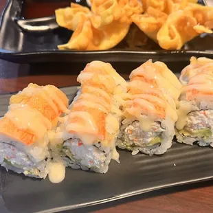 a plate of sushi and french fries