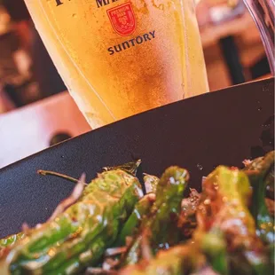 12oz Suntory beer, shishito peppers