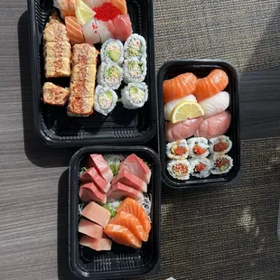 two trays of sushi on a table