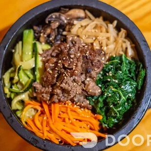 a bowl of food on a wooden table