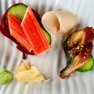 a variety of sushi on a white plate