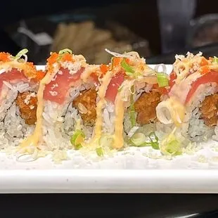a long platter of sushi rolls