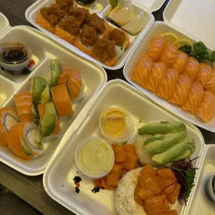 Top left Rainforest roll, top right Salmon nigiri, bottom left is Alaska Roll, bottom right is Salmon Ahi Tower