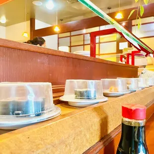 a row of cups and saucers on a counter