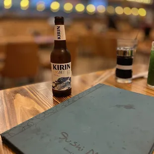 a bottle of beer and a menu