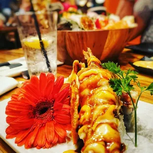 a plate of sushi and a flower