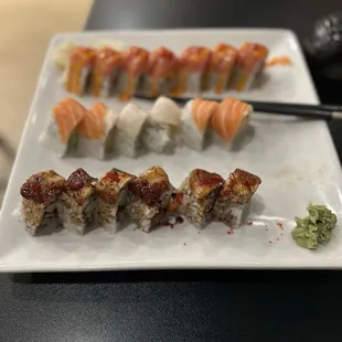 a plate of sushi and chopsticks