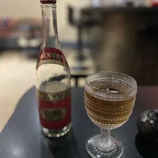 a glass of wine and a bottle of liquor