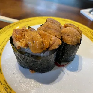 two pieces of sushi on a plate