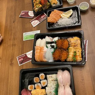 three trays of different types of sushi