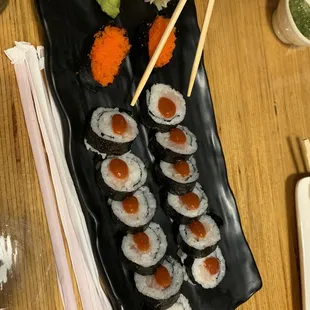 a plate of sushi and chopsticks