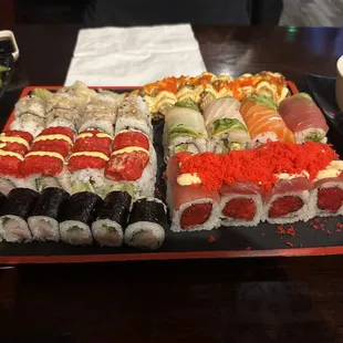 Back to front (left to right): baby octopus roll, sunrise roll, yellowtail scallion, Batman roll, rainbow roll, and Ahi Tuni roll