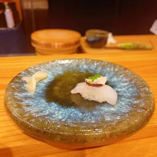 a plate of sushi on a wooden table