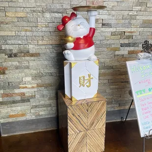 a statue of a person holding a sign