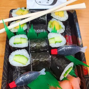 a tray of sushi and chopsticks
