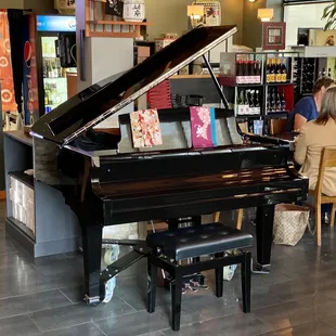 Piano in the center of the dining area at Sushi Mo restaurant