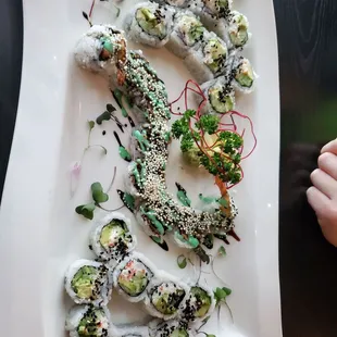 a plate of sushi and vegetables