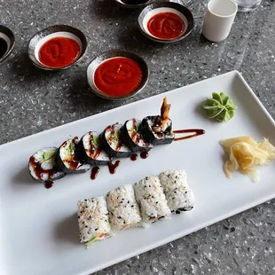 a plate of sushi and sauces