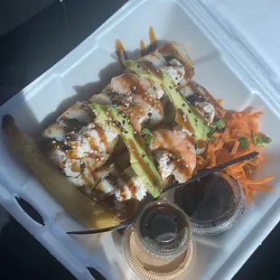 a styrofoam container of sushi