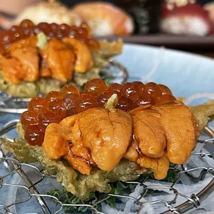 Uni with ikura on a fried ships leaf