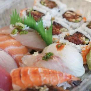 a variety of sushi in a plastic container