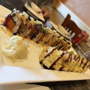 a large piece of sushi on a white plate