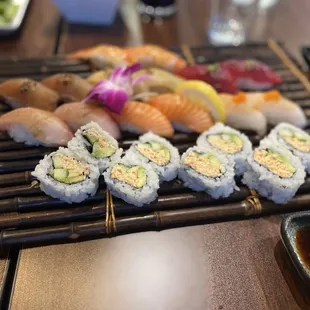 a variety of sushi on a bamboo mat