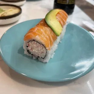 a sushi roll on a blue plate