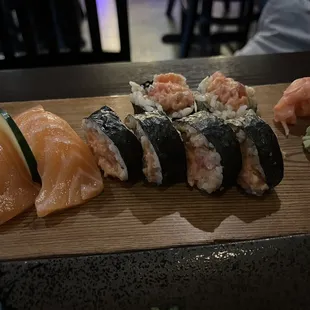 a variety of sushi on a wooden board