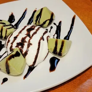 a plate of food with ice cream and chocolate sauce