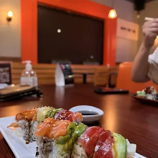 a woman eating sushi at a restaurant