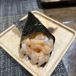 a sushi on a wooden plate