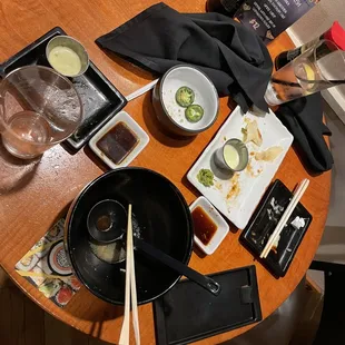 a table with a bowl of sushi and chopsticks
