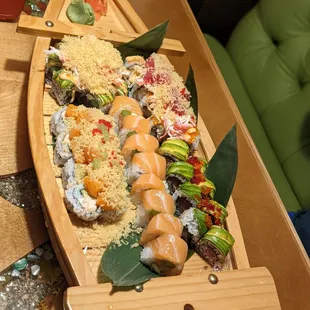 a wooden boat with sushi on it