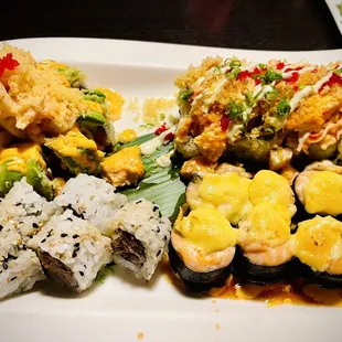 a plate of sushi and rolls