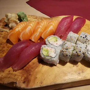 a variety of sushi on a wooden board
