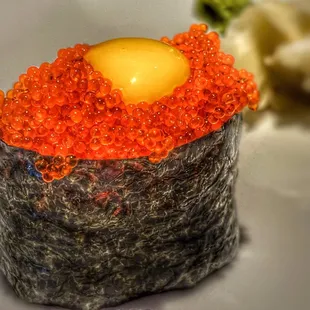 a sushi roll with red cavia