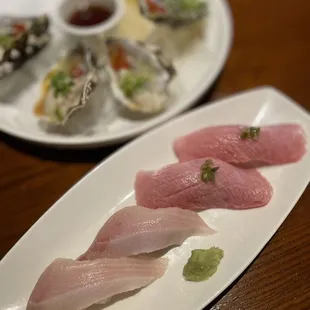 two plates of sushi on a table