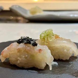 two pieces of sushi on a plate