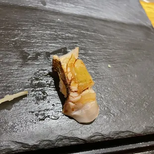 a piece of sushi on a slate