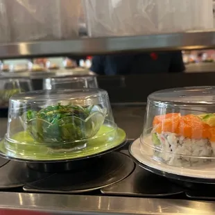 sushi and broccoli in plastic containers