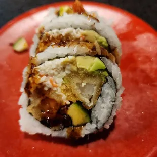 a sushi roll on a red plate