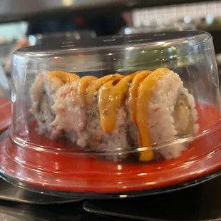 two plates of sushi on a counter