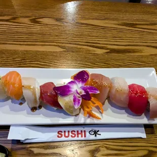 Fresh Sushi Okay Roll! Chopped shrimp, furikake, cucumber, avocado, asparagus with soy paper &amp; 10 kinds of fish on top.