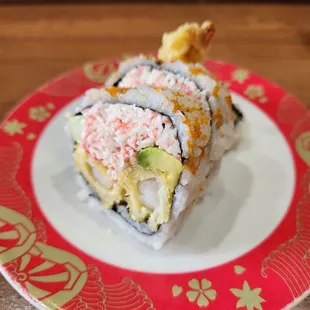 a plate of sushi on a wooden table