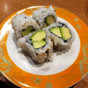 three pieces of sushi on a plate