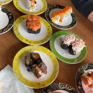 a variety of sushi on plates