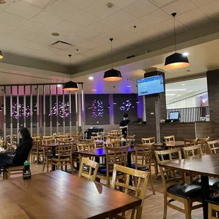 a restaurant with a large screen