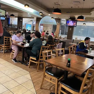 people sitting at tables in a restaurant