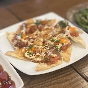 Jacob Special: Spicy tuna over fried wonton chips topped with masago, onions, cilantro, eel sauce &amp; mayo sauce | $15.95